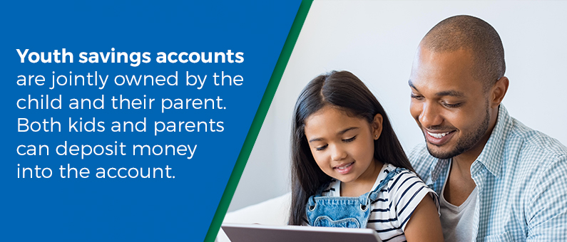 Youth savings accounts are jointly owned by the child and their parent. Both kids and parents can deposit money into the account - Image of a father and daughter looking at a tablet